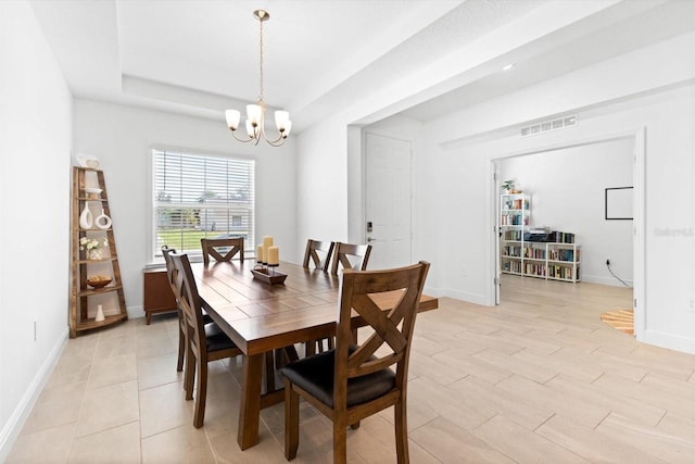 652 SW Mccoy Ave, Port St Lucie, FL 34953 - dining room featuring a chandelier, baseboards, and a tray ceiling