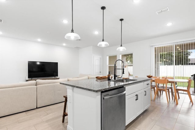 652 SW Mccoy Ave, Port St Lucie, FL 34953 - kitchen featuring stainless steel dishwasher, a sink, dark stone counters, recessed lighting, and a center island with sink