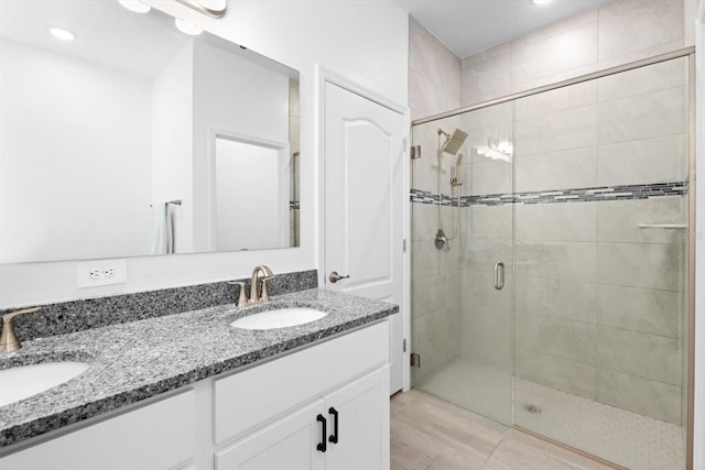 652 SW Mccoy Ave, Port St Lucie, FL 34953 - bathroom featuring a shower stall, double vanity, and recessed lighting