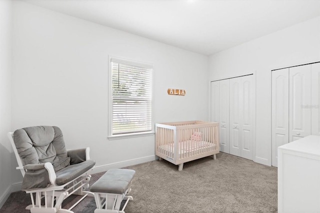 652 SW Mccoy Ave, Port St Lucie, FL 34953 - bedroom featuring two closets, carpet flooring, and baseboards