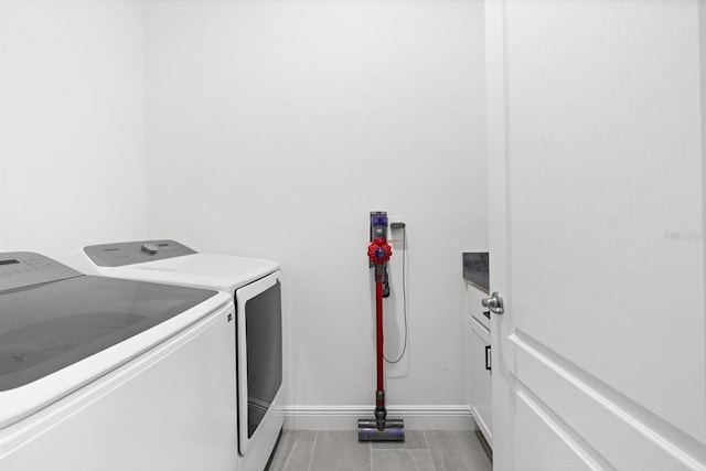 652 SW Mccoy Ave, Port St Lucie, FL 34953 - laundry room featuring independent washer and dryer, cabinet space, baseboards, and light tile patterned floors