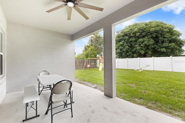 652 SW Mccoy Ave, Port St Lucie, FL 34953 - view of patio / terrace with ceiling fan and a playground