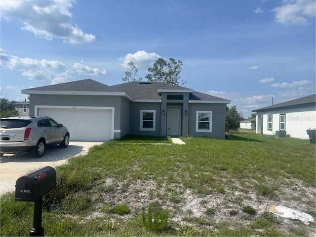 611 Amazon Pl, Kissimmee, FL 34759 - view of front of property featuring stucco siding, a front yard, driveway, an attached garage, and a shingled roof