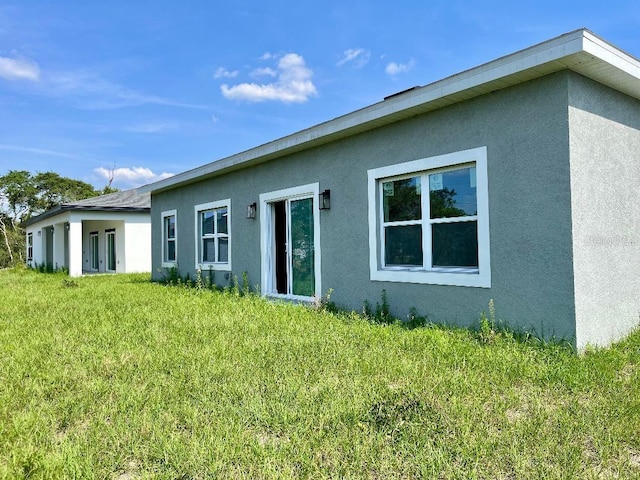 611 Amazon Pl, Kissimmee, FL 34759 - back of property featuring stucco siding