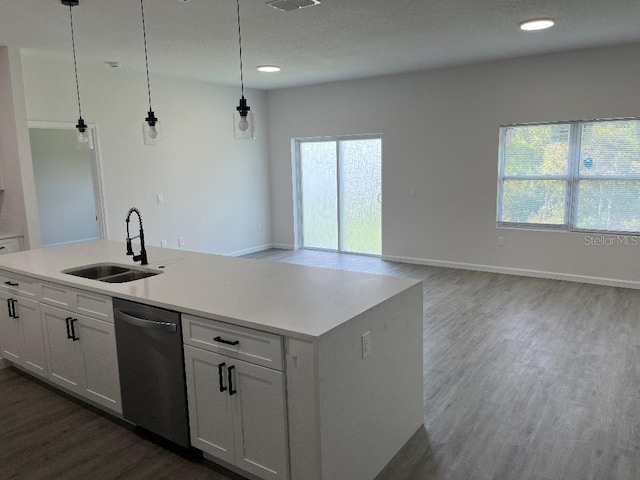 611 Amazon Pl, Kissimmee, FL 34759 - kitchen featuring a sink, stainless steel dishwasher, dark wood-type flooring, white cabinets, and a kitchen island with sink