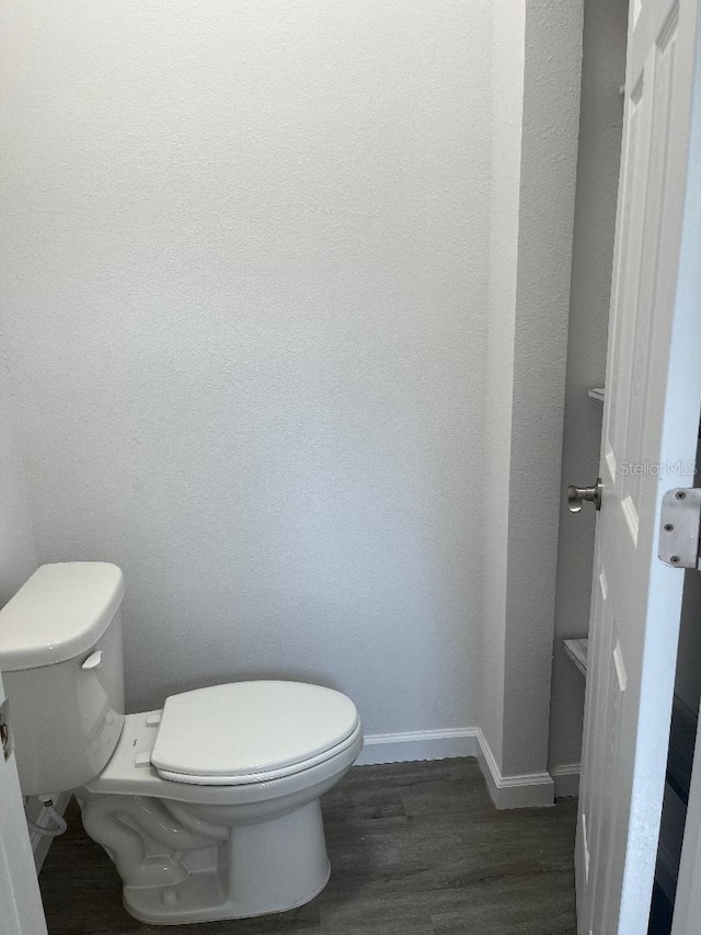 611 Amazon Pl, Kissimmee, FL 34759 - bathroom with toilet, wood finished floors, and baseboards
