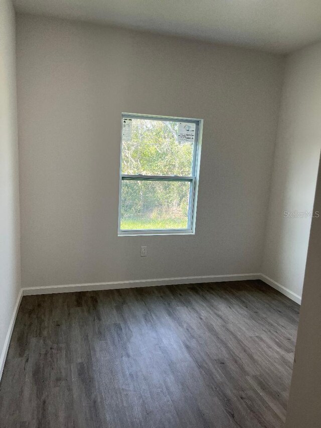 611 Amazon Pl, Kissimmee, FL 34759 - unfurnished room featuring dark wood finished floors and baseboards