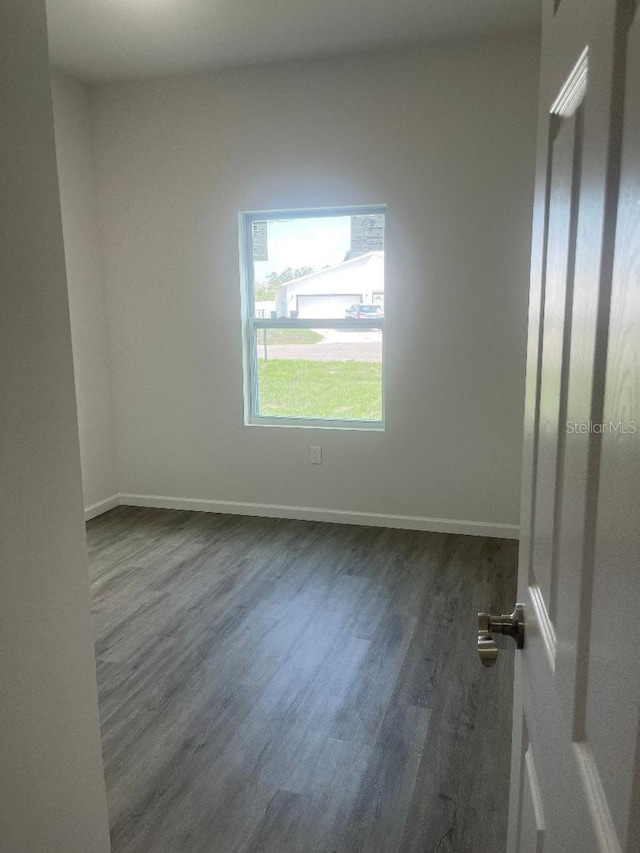 611 Amazon Pl, Kissimmee, FL 34759 - empty room featuring dark wood finished floors and baseboards