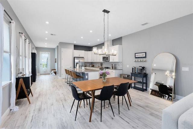13334 Beebe Aly, Orlando, FL 32827 - dining room with a chandelier, light wood-style flooring, baseboards, and recessed lighting