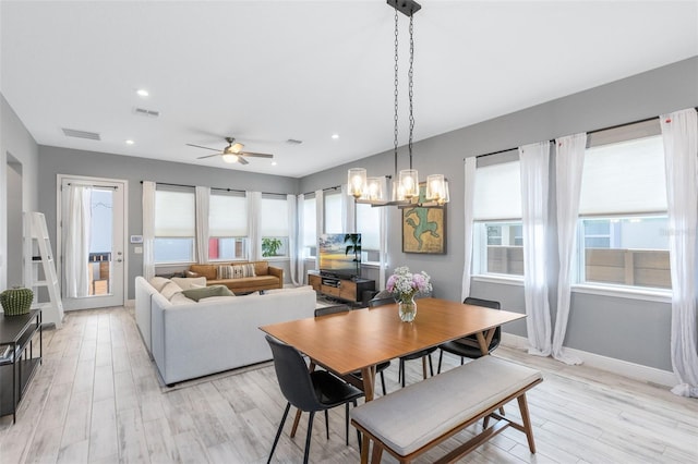 13334 Beebe Aly, Orlando, FL 32827 - dining room featuring healthy amount of natural light, light wood-style flooring, ceiling fan, a chandelier, and recessed lighting