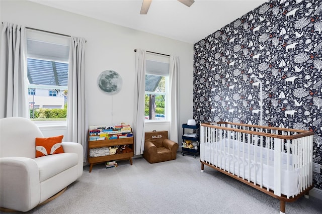13334 Beebe Aly, Orlando, FL 32827 - carpeted bedroom with a crib, wallpapered walls, and a ceiling fan