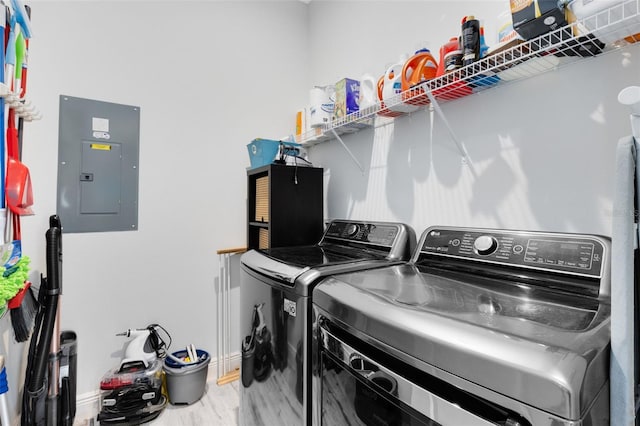 13334 Beebe Aly, Orlando, FL 32827 - laundry room with electric panel, washer and clothes dryer, baseboards, and wood finished floors