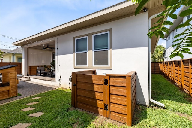 13334 Beebe Aly, Orlando, FL 32827 - back of property featuring stucco siding, ceiling fan, and a patio area