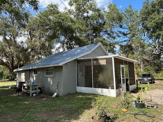 2847 Crk 756, Webster, FL 33597 - view of side of property with a sunroom, a lawn, and stucco siding