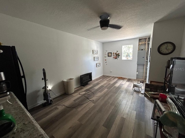 2847 Crk 756, Webster, FL 33597 - living room featuring wood finished floors, ceiling fan, a textured ceiling, and baseboards