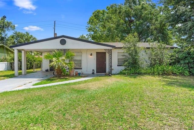 1877 Attucks Ave, Orlando, FL 32811 - view of front of house featuring driveway, a front yard, and stucco siding