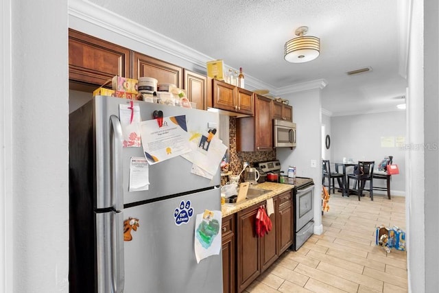 1877 Attucks Ave, Orlando, FL 32811 - kitchen with appliances with stainless steel finishes, ornamental molding, light countertops, and tasteful backsplash