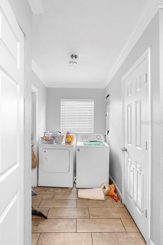 1877 Attucks Ave, Orlando, FL 32811 - washroom featuring ornamental molding, washer and clothes dryer, and wood tiled floors