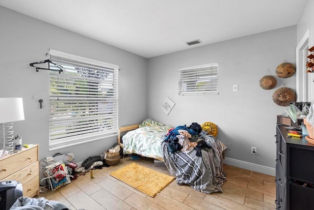 1877 Attucks Ave, Orlando, FL 32811 - bedroom featuring multiple windows, wood finished floors, and baseboards