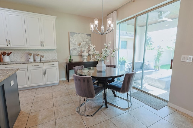 9257 Outlook Rock Trl, Windermere, FL 34786 - dining room with a chandelier, light tile patterned floors, and baseboards