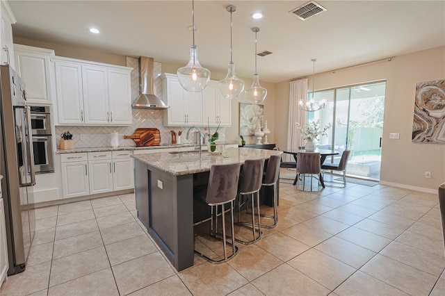 9257 Outlook Rock Trl, Windermere, FL 34786 - kitchen featuring wall chimney exhaust hood, tasteful backsplash, a sink, white cabinets, and recessed lighting