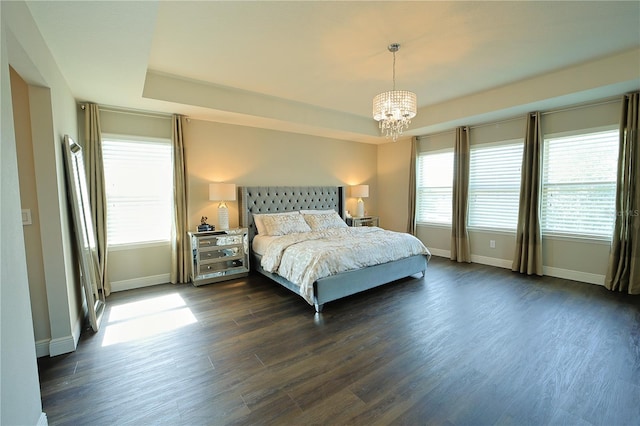 9257 Outlook Rock Trl, Windermere, FL 34786 - bedroom featuring baseboards, a chandelier, dark wood-style floors, and a tray ceiling