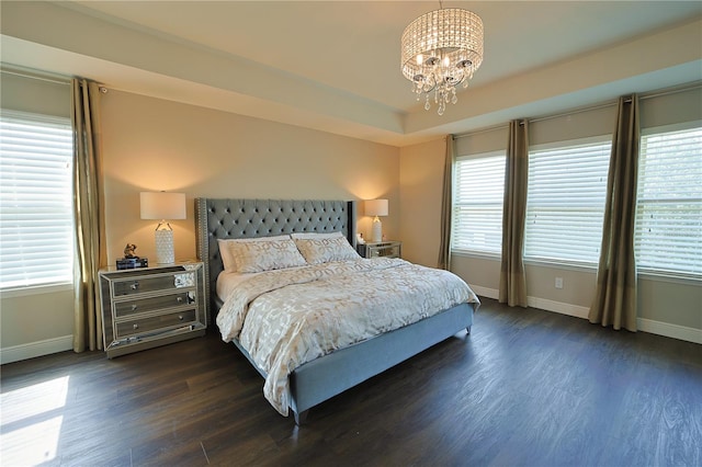 9257 Outlook Rock Trl, Windermere, FL 34786 - bedroom with baseboards, dark wood-style flooring, a chandelier, and multiple windows