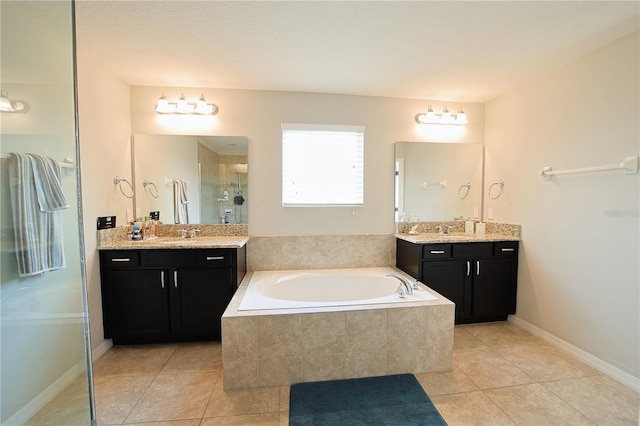 9257 Outlook Rock Trl, Windermere, FL 34786 - bathroom with tile patterned flooring, a stall shower, a bath, and two vanities