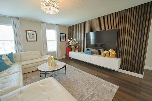 9257 Outlook Rock Trl, Windermere, FL 34786 - living room featuring an accent wall, baseboards, wood finished floors, and a chandelier