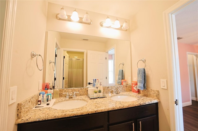9257 Outlook Rock Trl, Windermere, FL 34786 - full bath with double vanity, wood finished floors, and baseboards