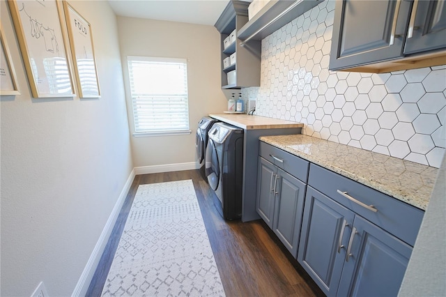 9257 Outlook Rock Trl, Windermere, FL 34786 - laundry area featuring cabinet space, separate washer and dryer, dark wood-style flooring, and baseboards