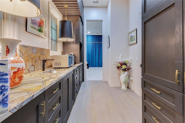 11103 Bridge House Rd, Windermere, FL 34786 - full bath with wood finished floors, double vanity, backsplash, and baseboards