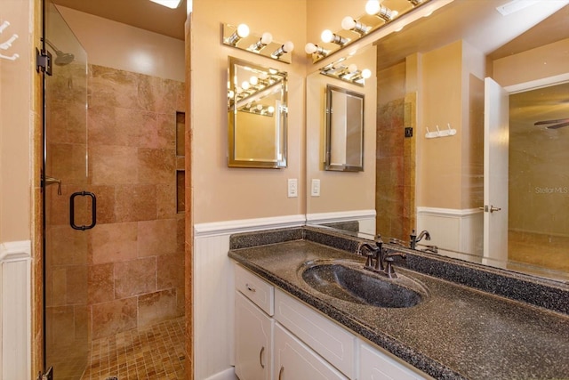 4739 Indian Gap Dr, Orlando, FL 32812 - full bath featuring vanity, a stall shower, and a wainscoted wall