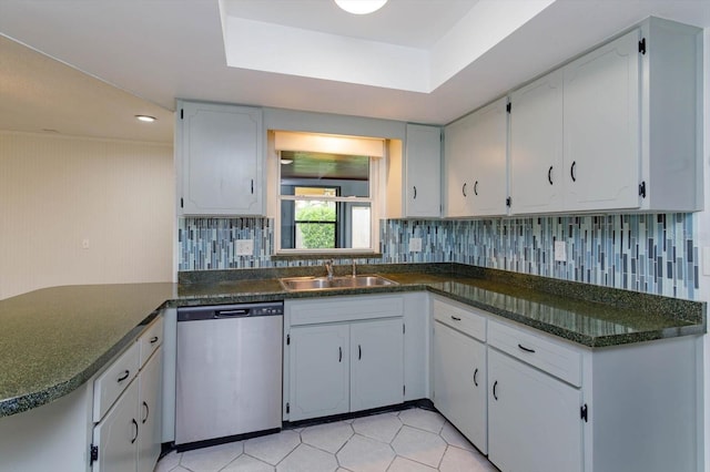 4739 Indian Gap Dr, Orlando, FL 32812 - kitchen featuring dishwasher, a sink, dark countertops, a peninsula, and tasteful backsplash