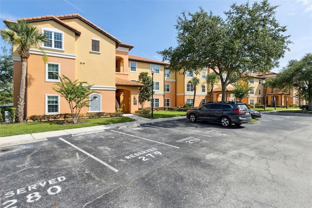 5467 Vineland Rd Unit 6110, Orlando, FL 32811 - view of property featuring uncovered parking