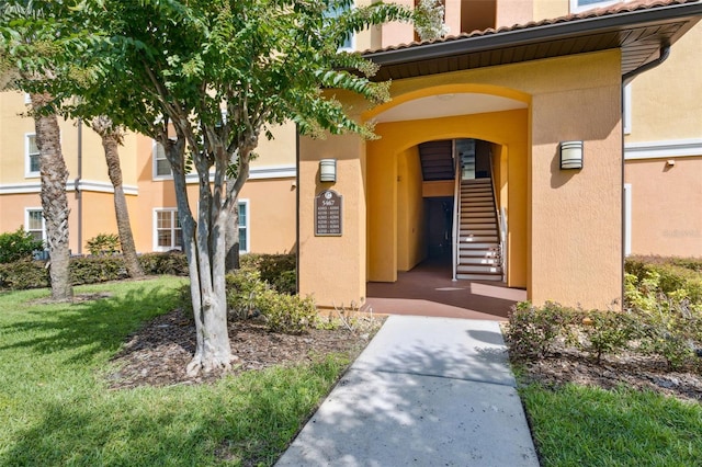 5467 Vineland Rd Unit 6110, Orlando, FL 32811 - property entrance with stucco siding and a tile roof