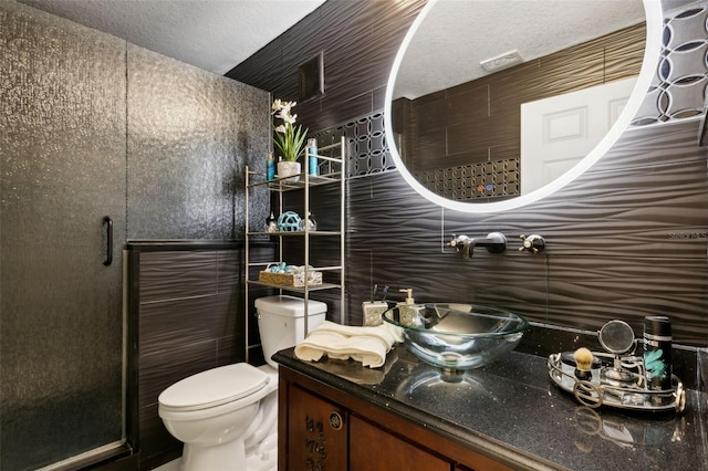 5467 Vineland Rd Unit 6110, Orlando, FL 32811 - bathroom featuring a stall shower, vanity, backsplash, and a textured ceiling