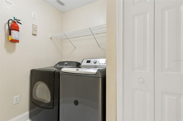5467 Vineland Rd Unit 6110, Orlando, FL 32811 - washroom featuring washing machine and dryer and baseboards