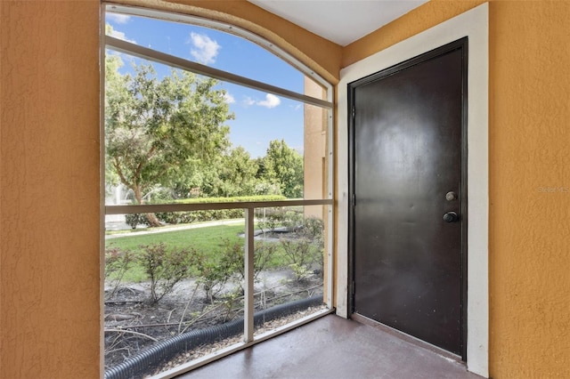 5467 Vineland Rd Unit 6110, Orlando, FL 32811 - doorway to outside with a textured wall and finished concrete floors