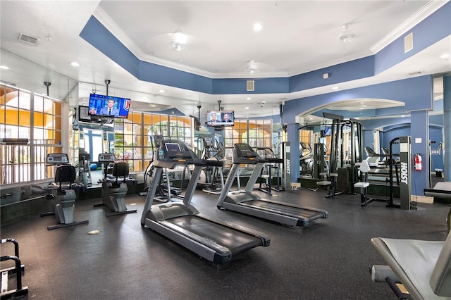 5467 Vineland Rd Unit 6110, Orlando, FL 32811 - gym featuring crown molding and a tray ceiling