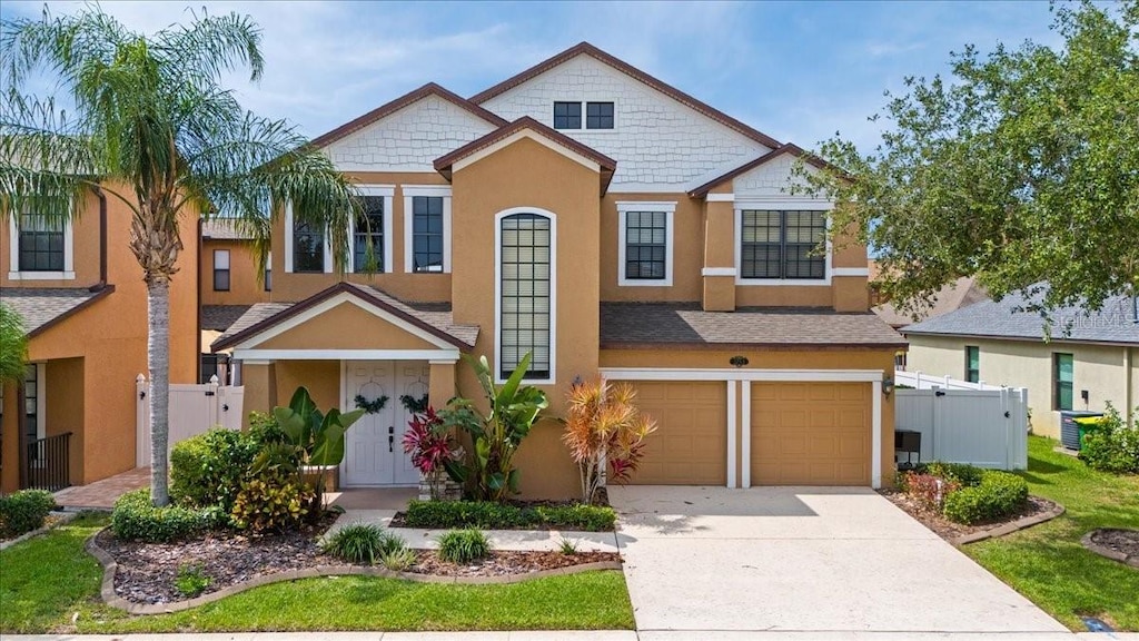2753 Glenridge Cir, Merritt Island, FL 32953 - view of front of house featuring stucco siding, an attached garage, concrete driveway, and central AC unit
