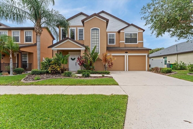 2753 Glenridge Cir, Merritt Island, FL 32953 - view of front facade featuring stucco siding, a garage, driveway, and a front yard