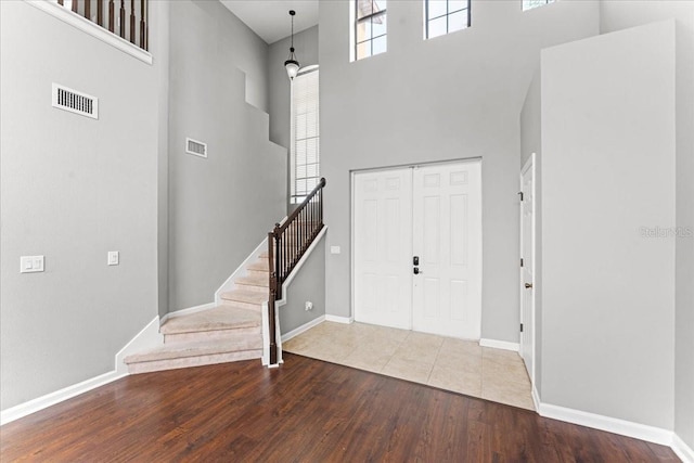 2753 Glenridge Cir, Merritt Island, FL 32953 - entrance foyer with a towering ceiling, wood finished floors, stairs, and baseboards