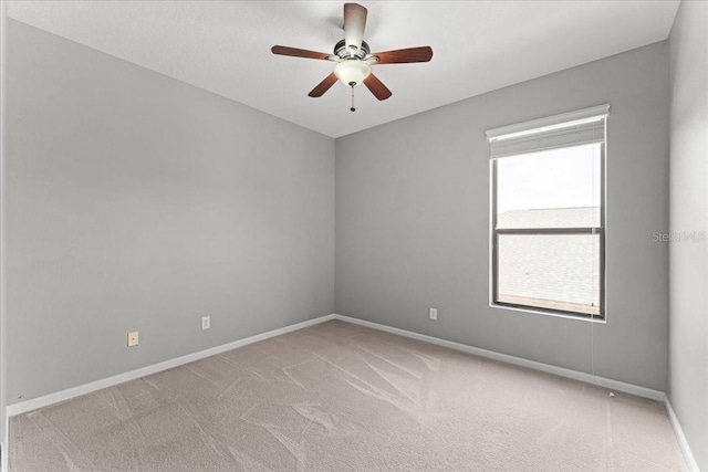 2753 Glenridge Cir, Merritt Island, FL 32953 - empty room with light colored carpet, a ceiling fan, and baseboards