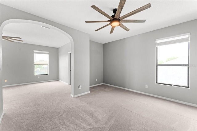 2753 Glenridge Cir, Merritt Island, FL 32953 - spare room with ceiling fan, carpet floors, arched walkways, and baseboards