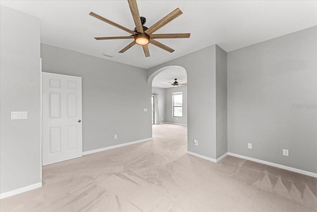 2753 Glenridge Cir, Merritt Island, FL 32953 - unfurnished room featuring a ceiling fan, light carpet, arched walkways, and baseboards