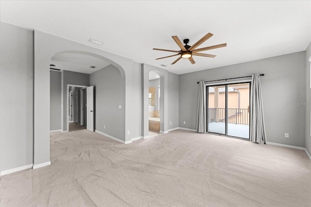 2753 Glenridge Cir, Merritt Island, FL 32953 - empty room with arched walkways, ceiling fan, light carpet, and baseboards