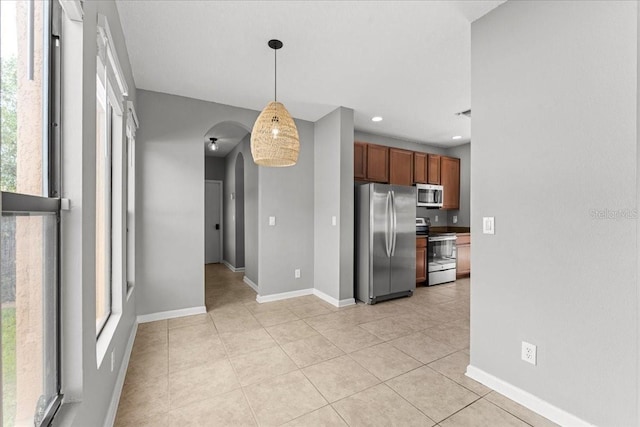 2753 Glenridge Cir, Merritt Island, FL 32953 - kitchen featuring stainless steel appliances, arched walkways, light tile patterned flooring, plenty of natural light, and recessed lighting