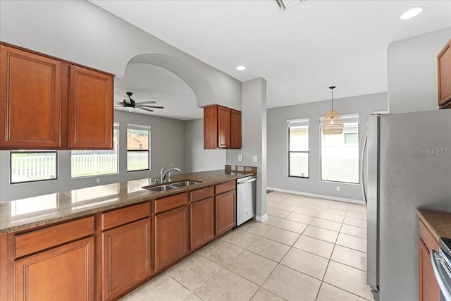 2753 Glenridge Cir, Merritt Island, FL 32953 - kitchen featuring a sink, appliances with stainless steel finishes, brown cabinetry, and light tile patterned flooring