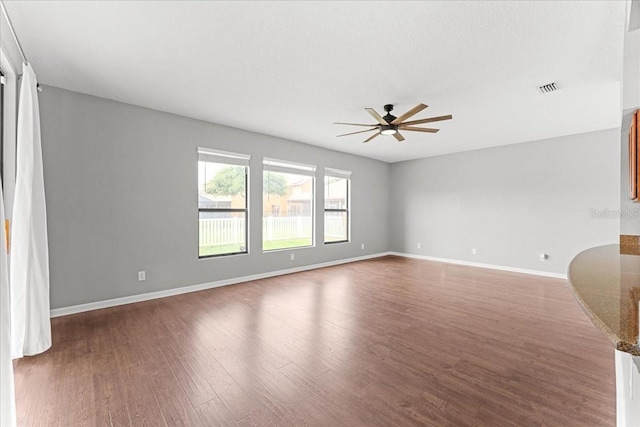 2753 Glenridge Cir, Merritt Island, FL 32953 - empty room with a ceiling fan, wood finished floors, and baseboards
